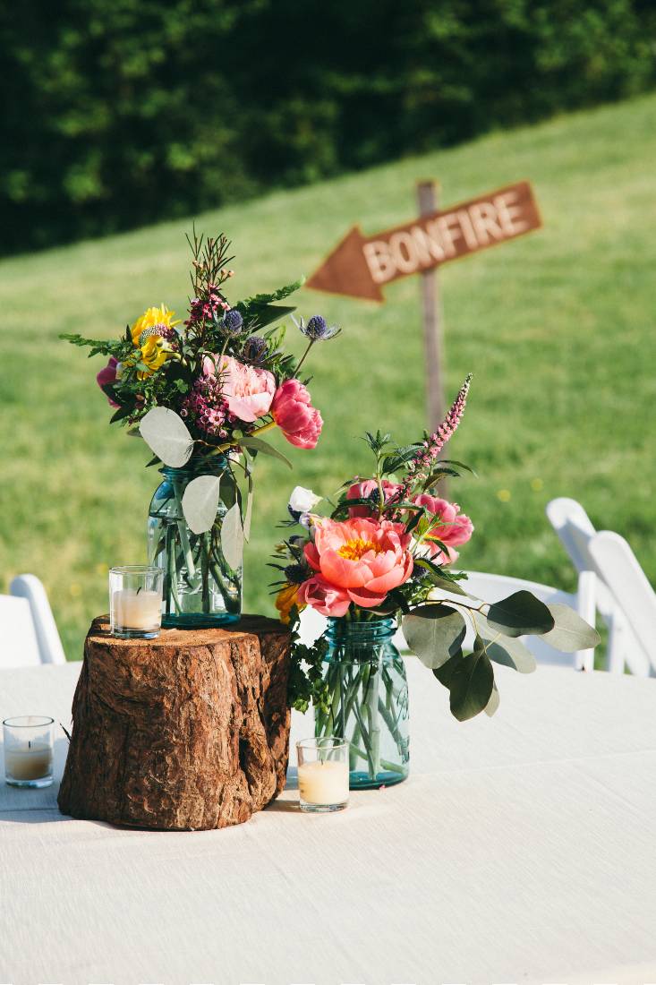 An outdoor table arrangement with colorful flowers at a Tennessee mountain wedding venue